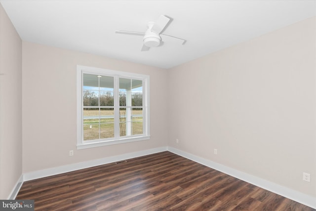 unfurnished room with ceiling fan and dark wood-type flooring