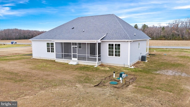 back of property with central AC and a sunroom