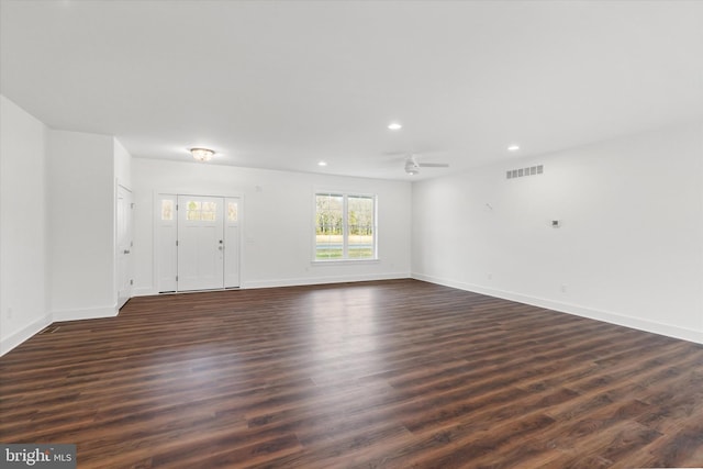 spare room with dark hardwood / wood-style flooring and ceiling fan