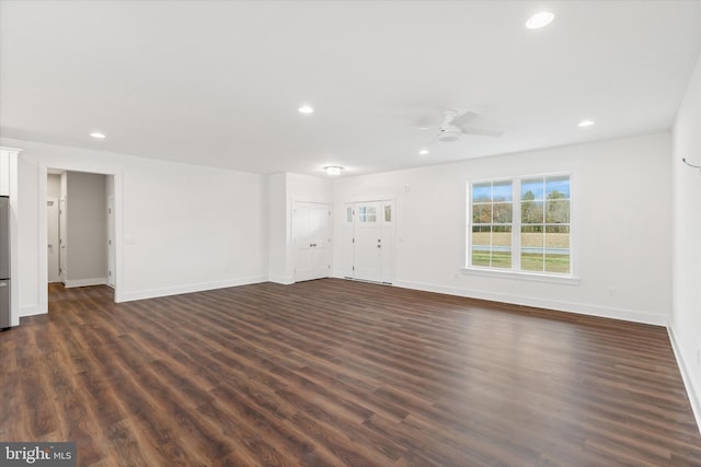 unfurnished living room featuring dark hardwood / wood-style floors and ceiling fan