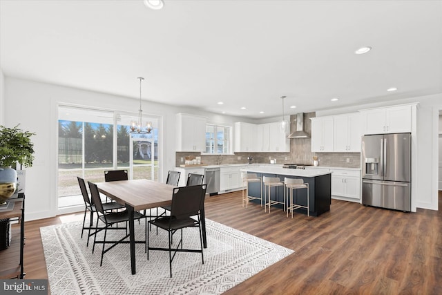 dining area featuring dark hardwood / wood-style floors and a notable chandelier