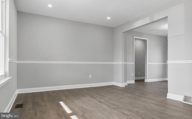 unfurnished room with dark hardwood / wood-style flooring