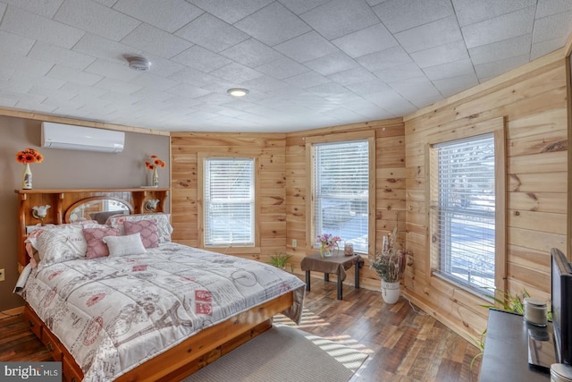 bedroom featuring an AC wall unit, wood walls, and wood-type flooring