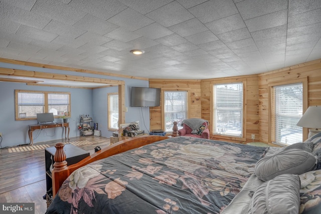 bedroom featuring wooden walls and wood-type flooring