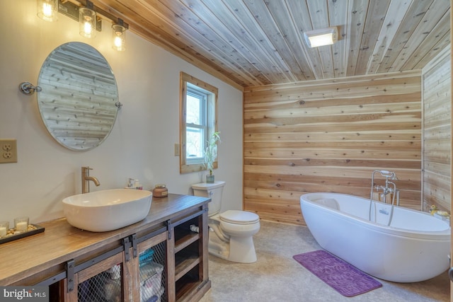 bathroom featuring wood ceiling, a washtub, vanity, toilet, and wood walls