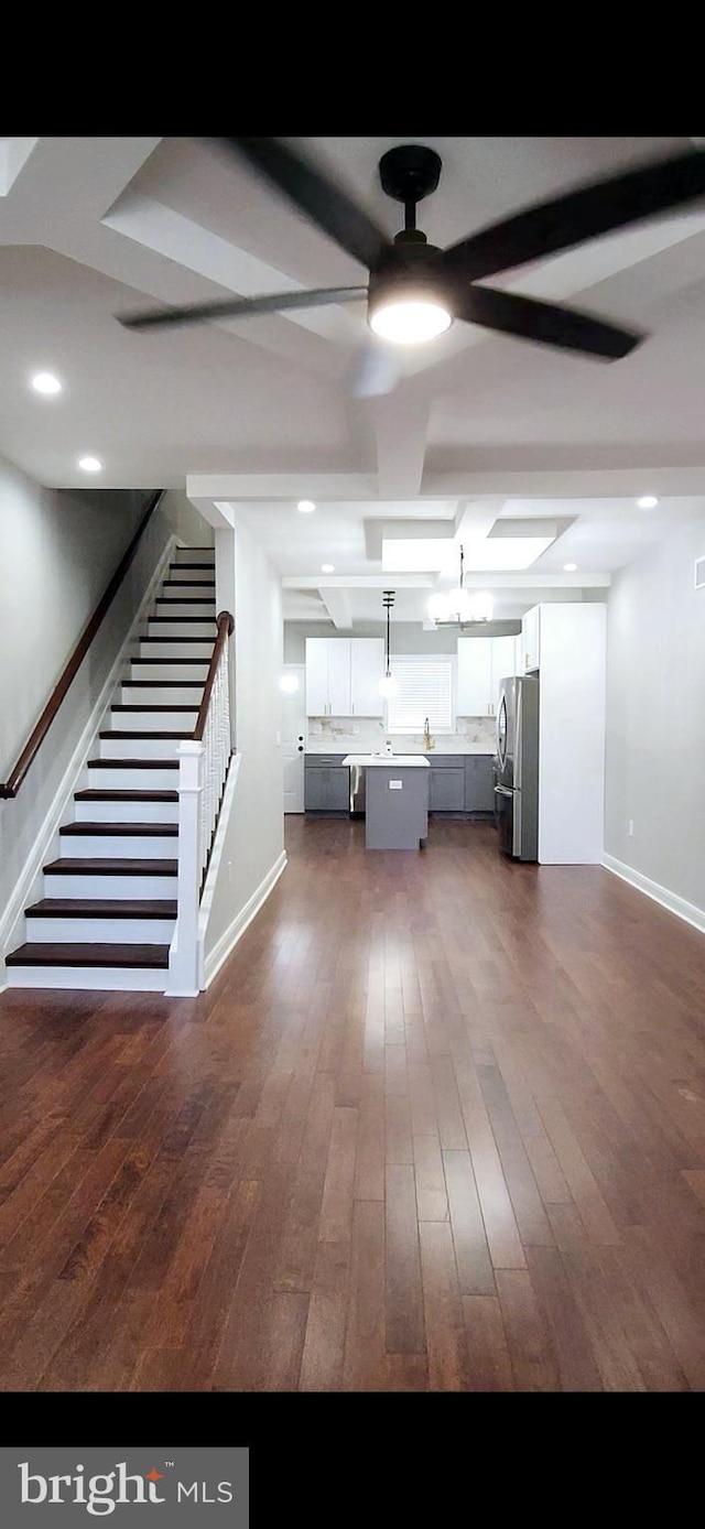 kitchen with baseboards, dark wood-style flooring, freestanding refrigerator, and white cabinetry