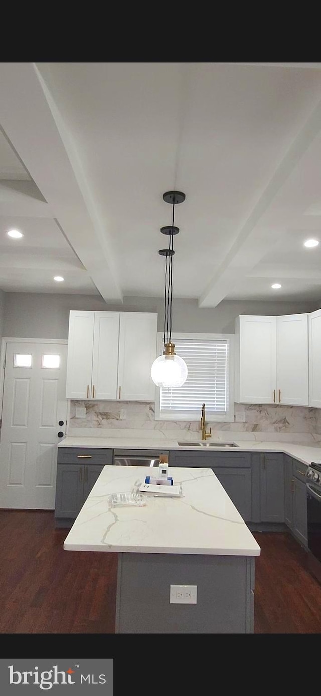 kitchen featuring dark wood-style flooring, gray cabinets, a sink, and beam ceiling