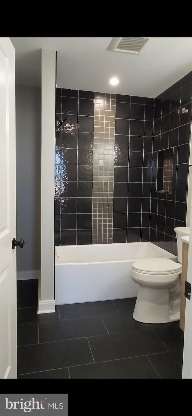 bathroom featuring toilet, tile patterned flooring, visible vents, and tub / shower combination