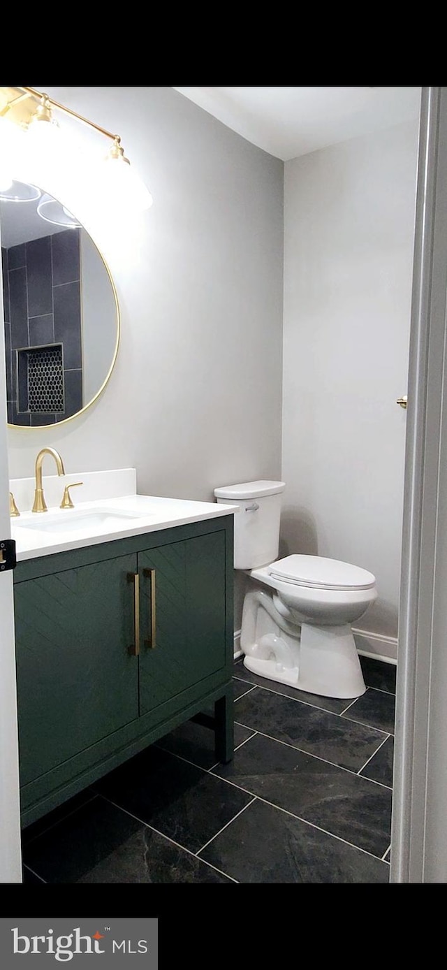 half bath with vanity and toilet