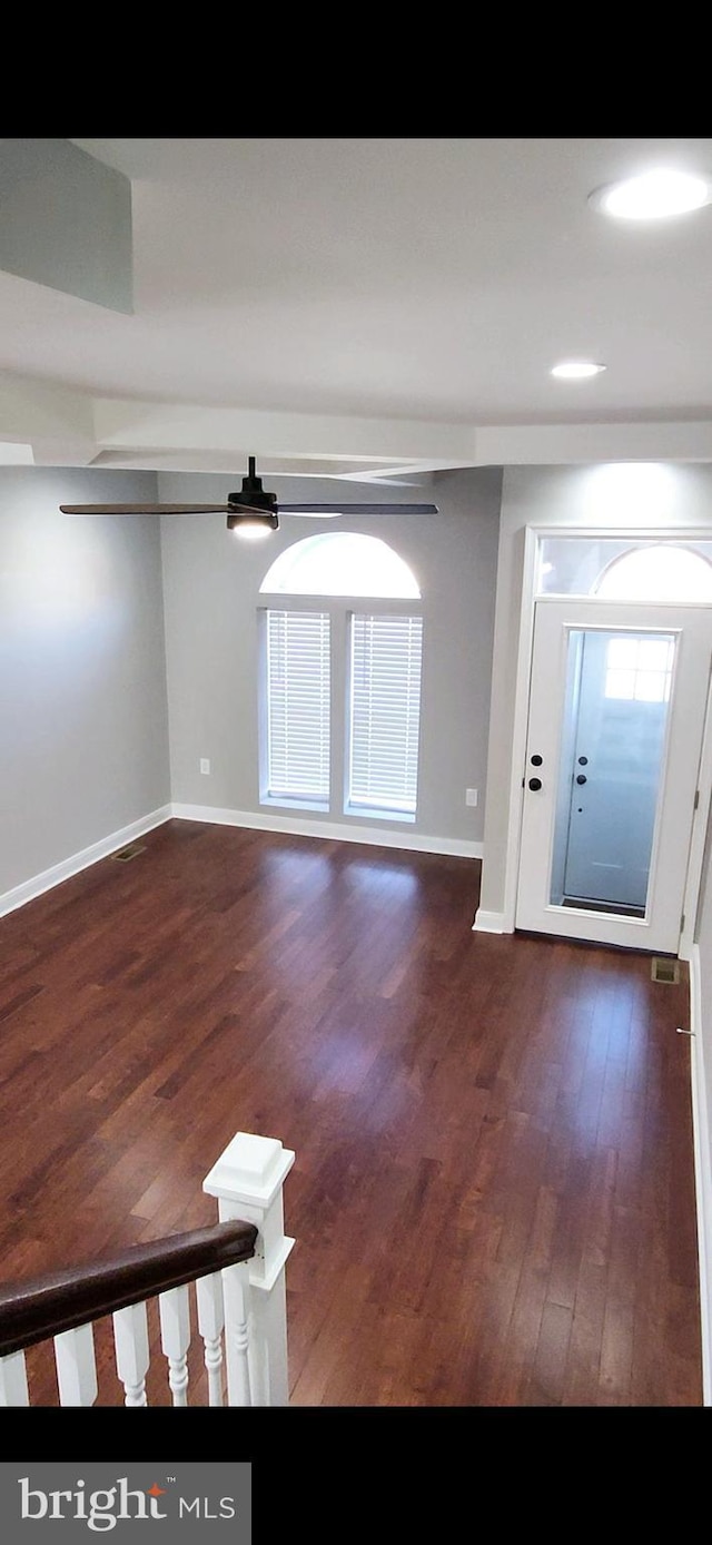 entryway featuring visible vents, baseboards, and wood finished floors