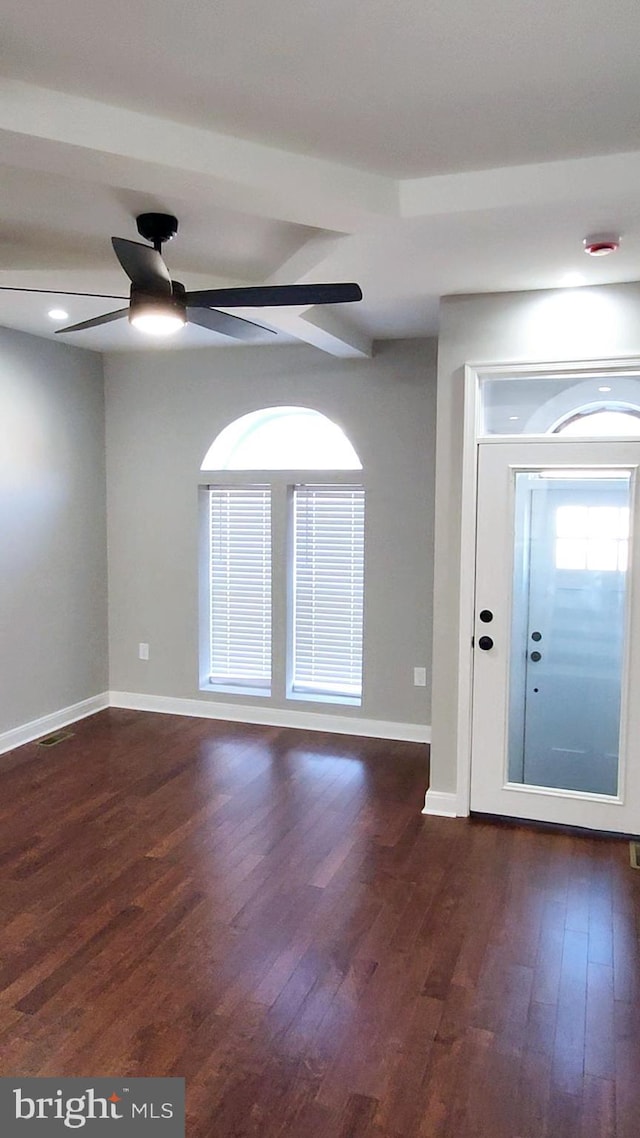 foyer featuring ceiling fan, baseboards, dark wood finished floors, and beam ceiling