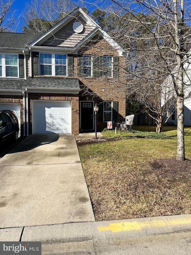 view of property featuring a front yard and a garage