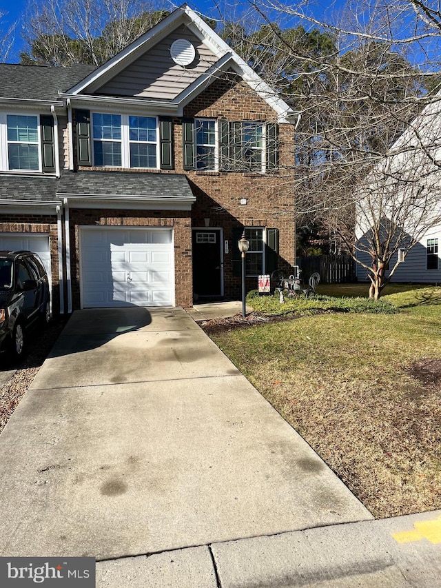 view of front facade featuring a garage and a front lawn