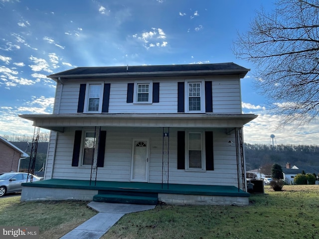 front of property with covered porch and a front lawn