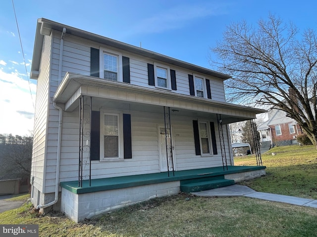 view of front of home featuring covered porch and a front yard