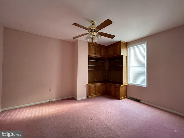 interior space featuring ceiling fan and light colored carpet