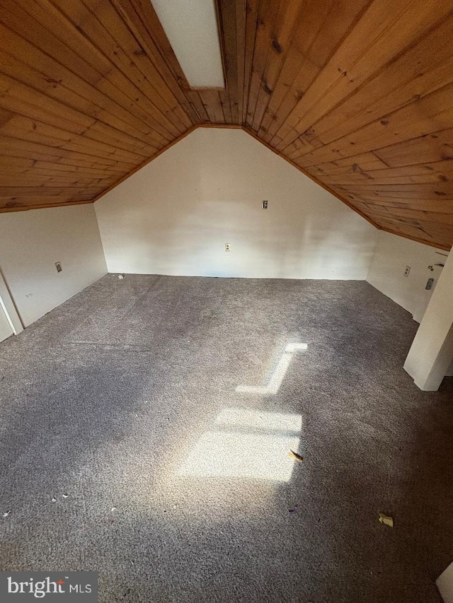 additional living space with carpet flooring, lofted ceiling, and wooden ceiling