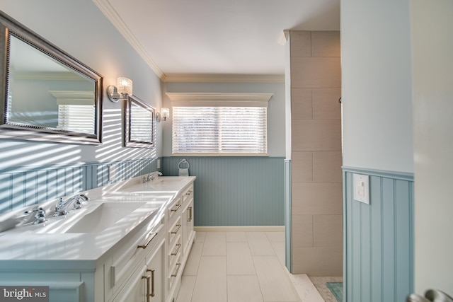 bathroom with a wealth of natural light, crown molding, and vanity