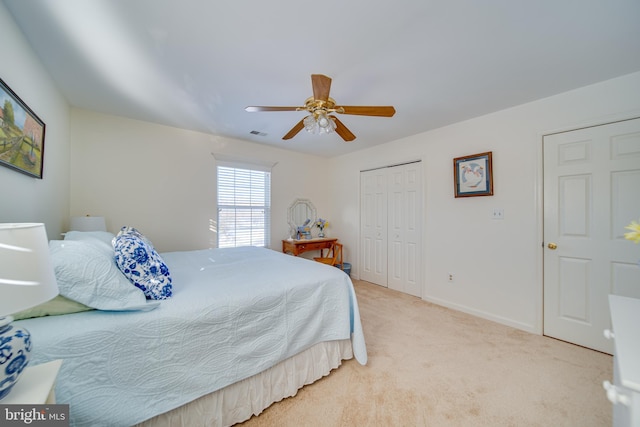 carpeted bedroom with a closet and ceiling fan