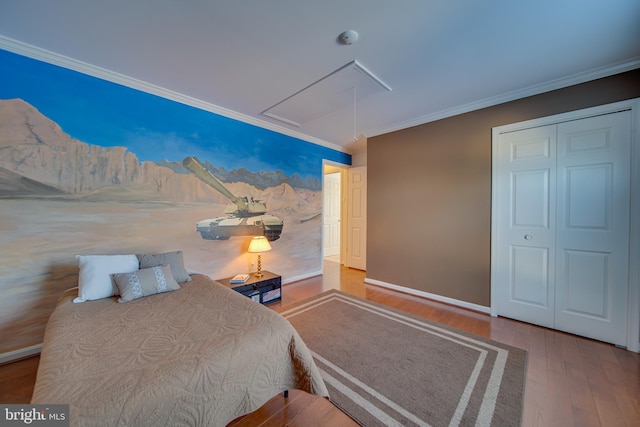 bedroom featuring crown molding, a closet, and wood-type flooring