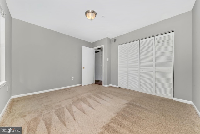 unfurnished bedroom with a closet and carpet