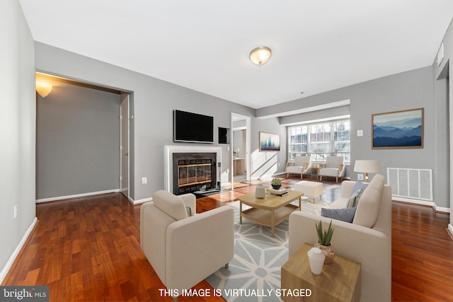 living room with dark hardwood / wood-style flooring