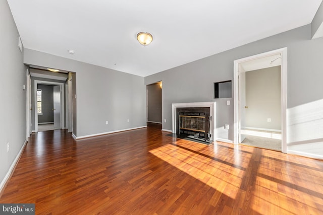 unfurnished living room featuring dark hardwood / wood-style flooring