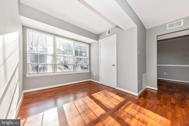 spare room featuring dark wood-type flooring