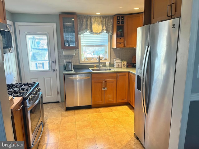 kitchen featuring stainless steel appliances, tasteful backsplash, and sink