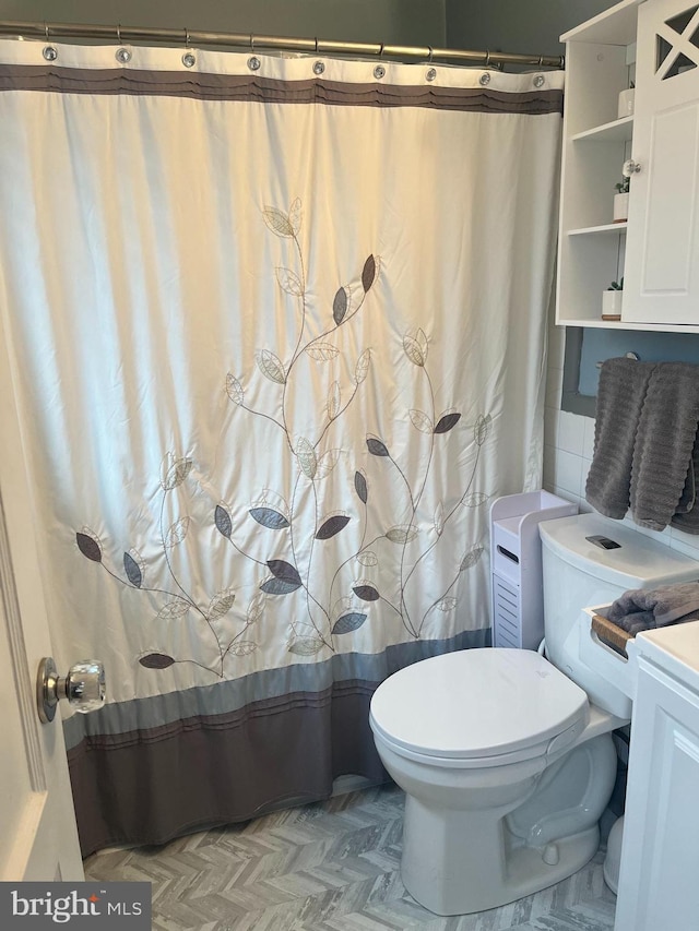 bathroom with toilet and vanity