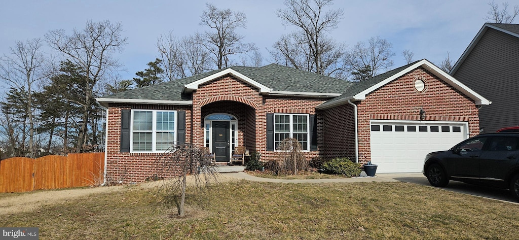 view of front facade featuring a front yard and a garage