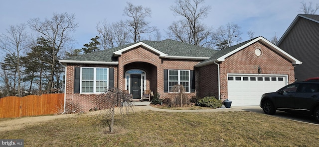 view of front facade featuring a front yard and a garage