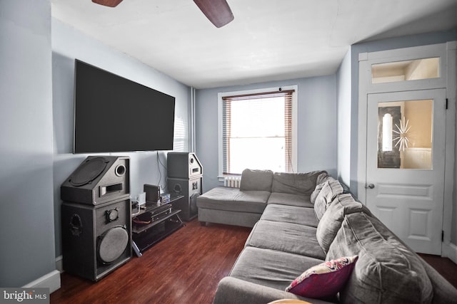 living room featuring dark hardwood / wood-style floors and ceiling fan