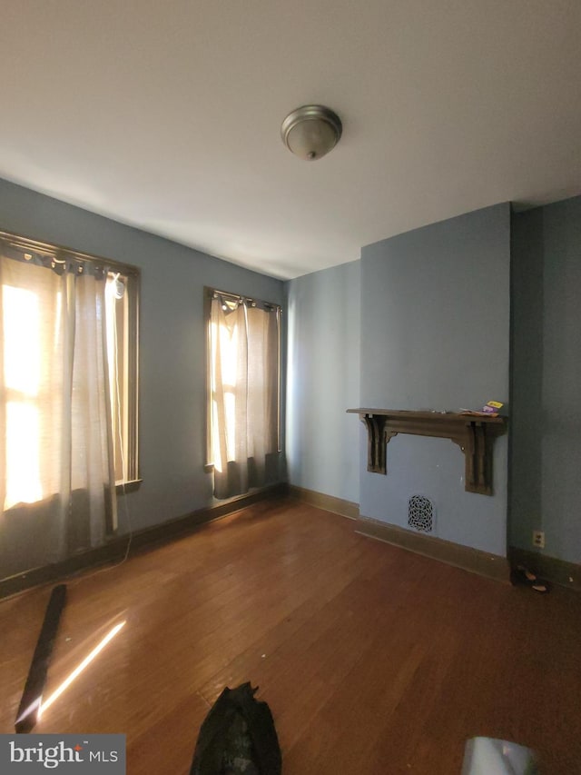 unfurnished living room featuring hardwood / wood-style flooring