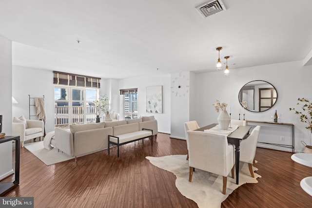 dining space featuring dark wood-type flooring and a baseboard radiator