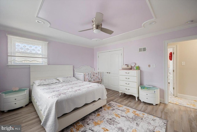 bedroom featuring wood-type flooring, ceiling fan, and crown molding