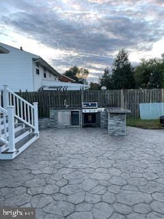 view of patio / terrace featuring area for grilling and a grill