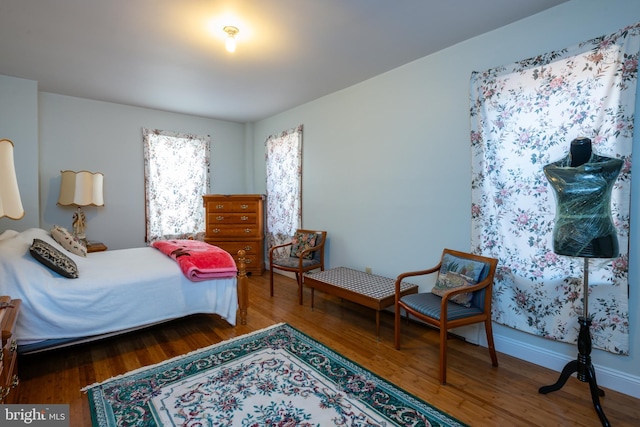 bedroom with baseboards and wood finished floors