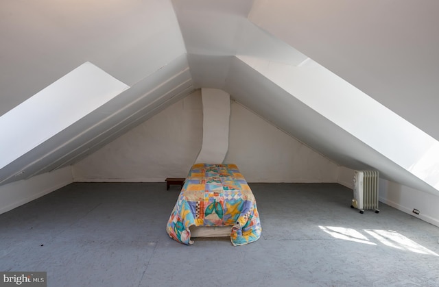 bonus room with vaulted ceiling and radiator