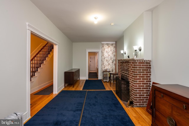 interior space with light wood finished floors, stairs, and baseboards