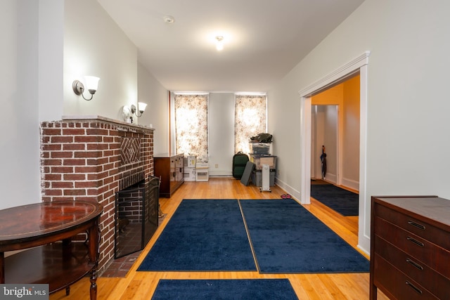 interior space featuring a fireplace, baseboards, and wood finished floors