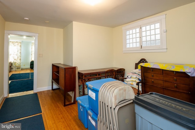 bedroom featuring baseboards and wood finished floors