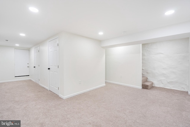 basement featuring light carpet