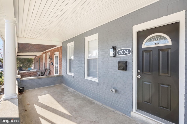 view of exterior entry with covered porch