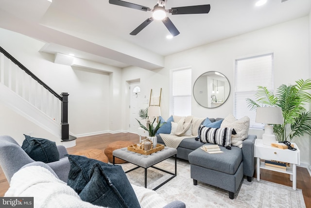 living room featuring light hardwood / wood-style flooring and ceiling fan