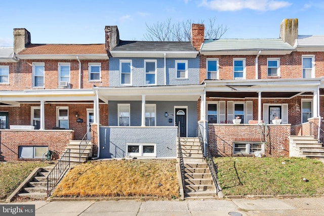 townhome / multi-family property featuring a porch