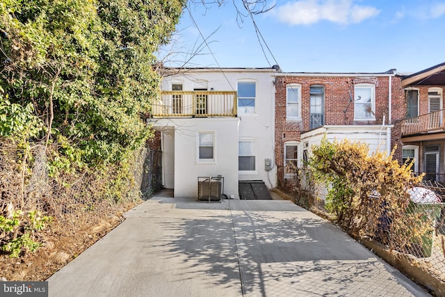 rear view of property with a balcony