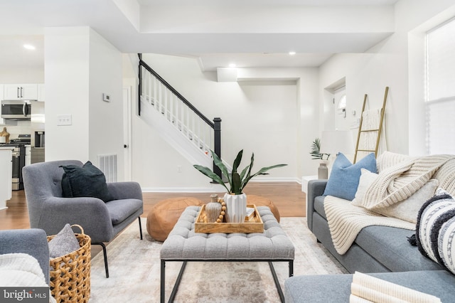 living room with light hardwood / wood-style flooring