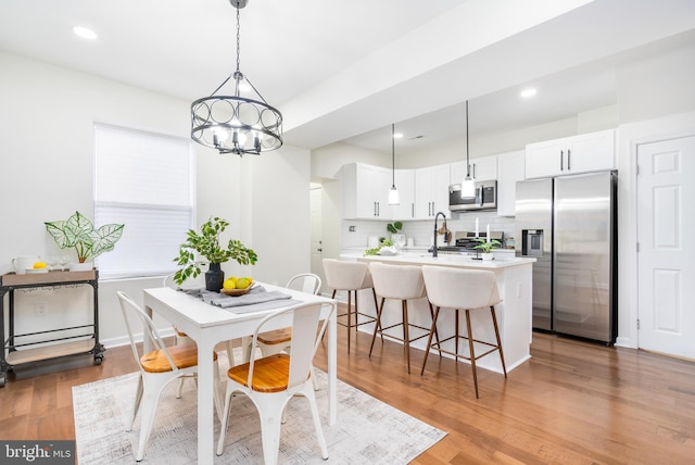 dining room featuring light hardwood / wood-style floors and an inviting chandelier