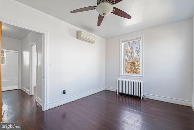 empty room featuring ceiling fan, dark hardwood / wood-style flooring, radiator heating unit, and a wall unit AC